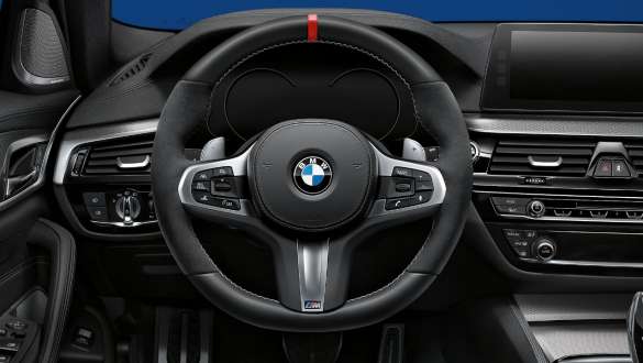 BMW 3 Series Sedan, M Performance steering wheel. Close-up view of the BMW 3 Series Sedan with focus on the BMW M Performance steering wheel.
