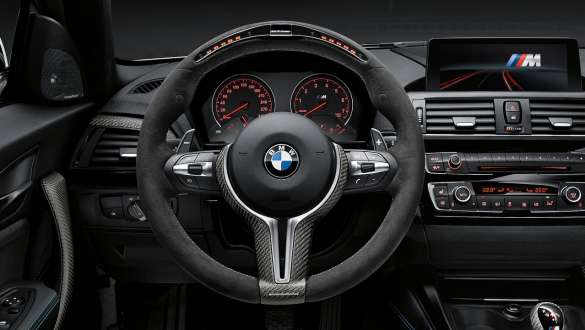 BMW 3 Series Sedan, M Performance Parts steering wheel II. Close-up view of the BMW 3 Series Sedan with focus on the BMW M Performance Parts steering wheel II Alcantara with carbon fibre trim.