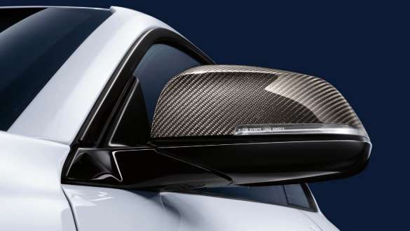 BMW 3 Series Sedan, M Performance exterior mirror caps. Close-up view of the BMW 3 Series Sedan with focus on the BMW M Performance exterior mirror caps carbon fibre.