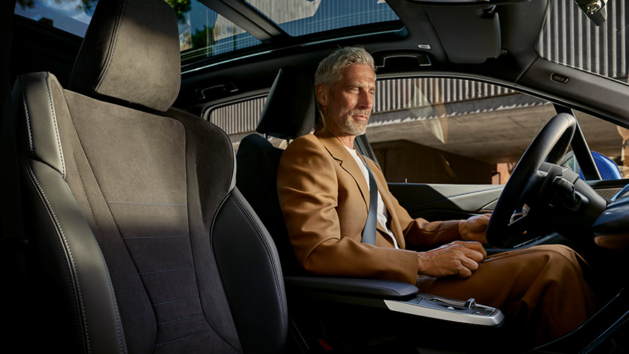 BMW 2 Series Active Tourer with mild hybrid technology U06 2021 cockpit with person behind the steering wheel