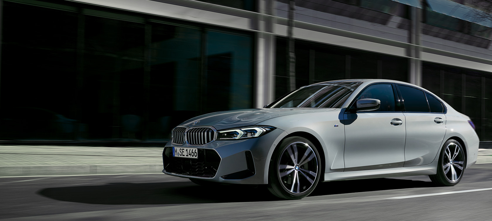 BMW 3 Series Saloon LCI G20 Brookly Grey side view standing in front of wall