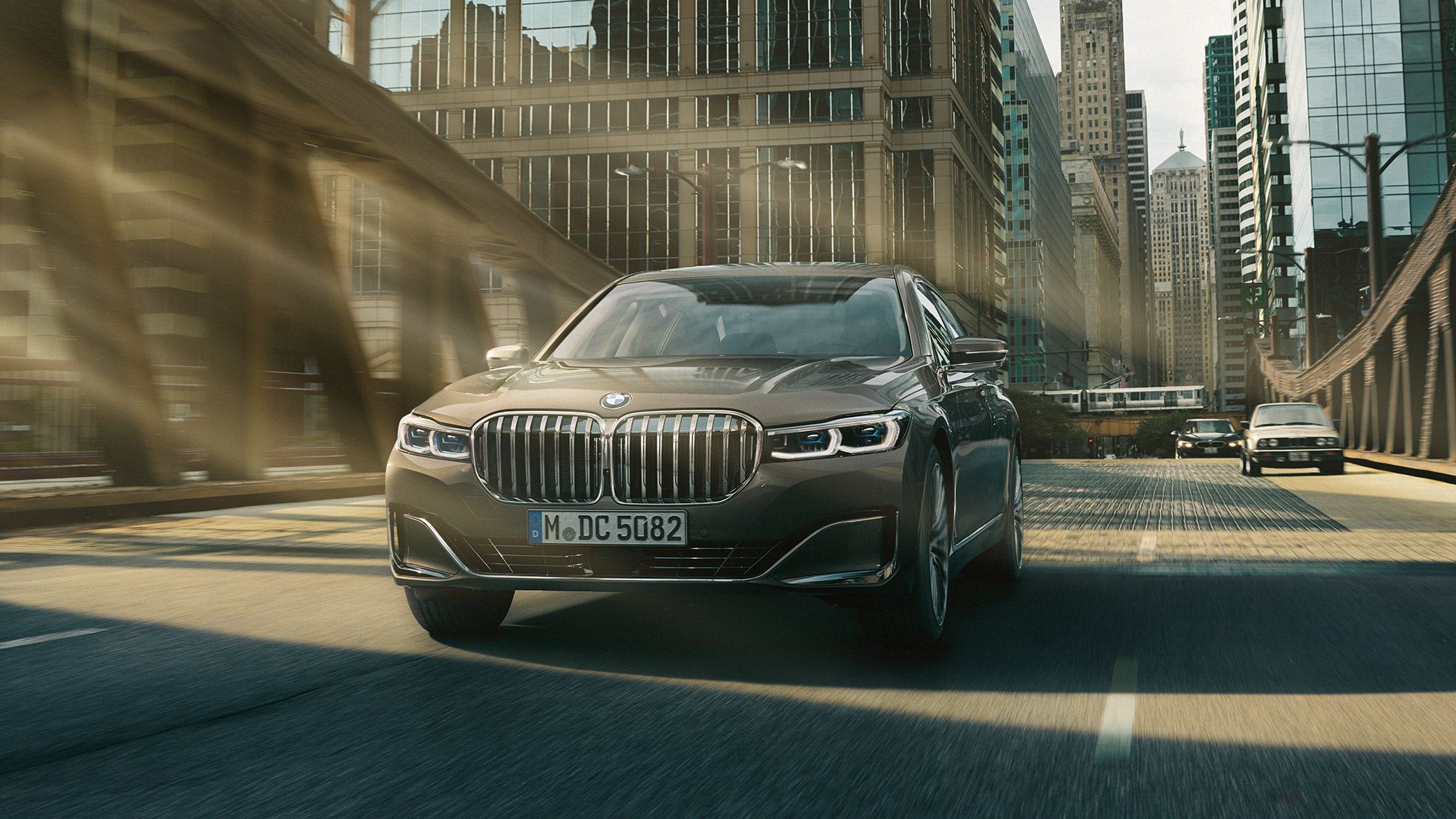 BMW 7 Series Sedan Driving Assistance Systems Driving Assistance Systems: BMW 7 Series Sedan driving in front of urban setting