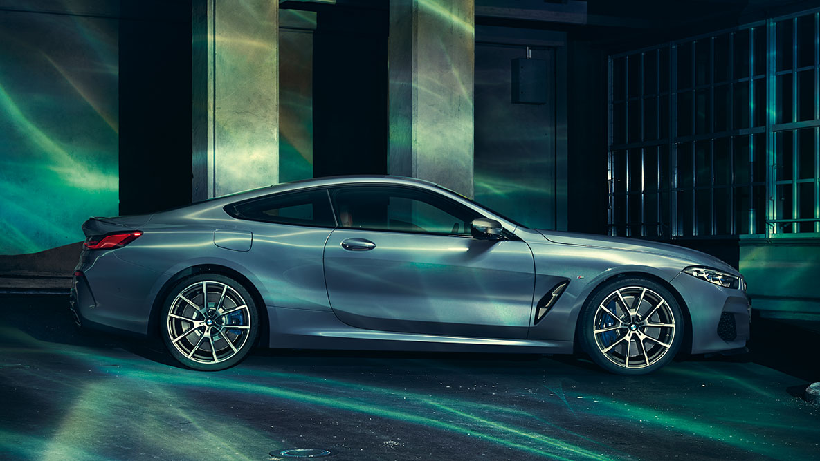 The BMW 8 Series Coupé, side view. A still shot of the BMW 8 Series Coupé from the side in an urban setting.