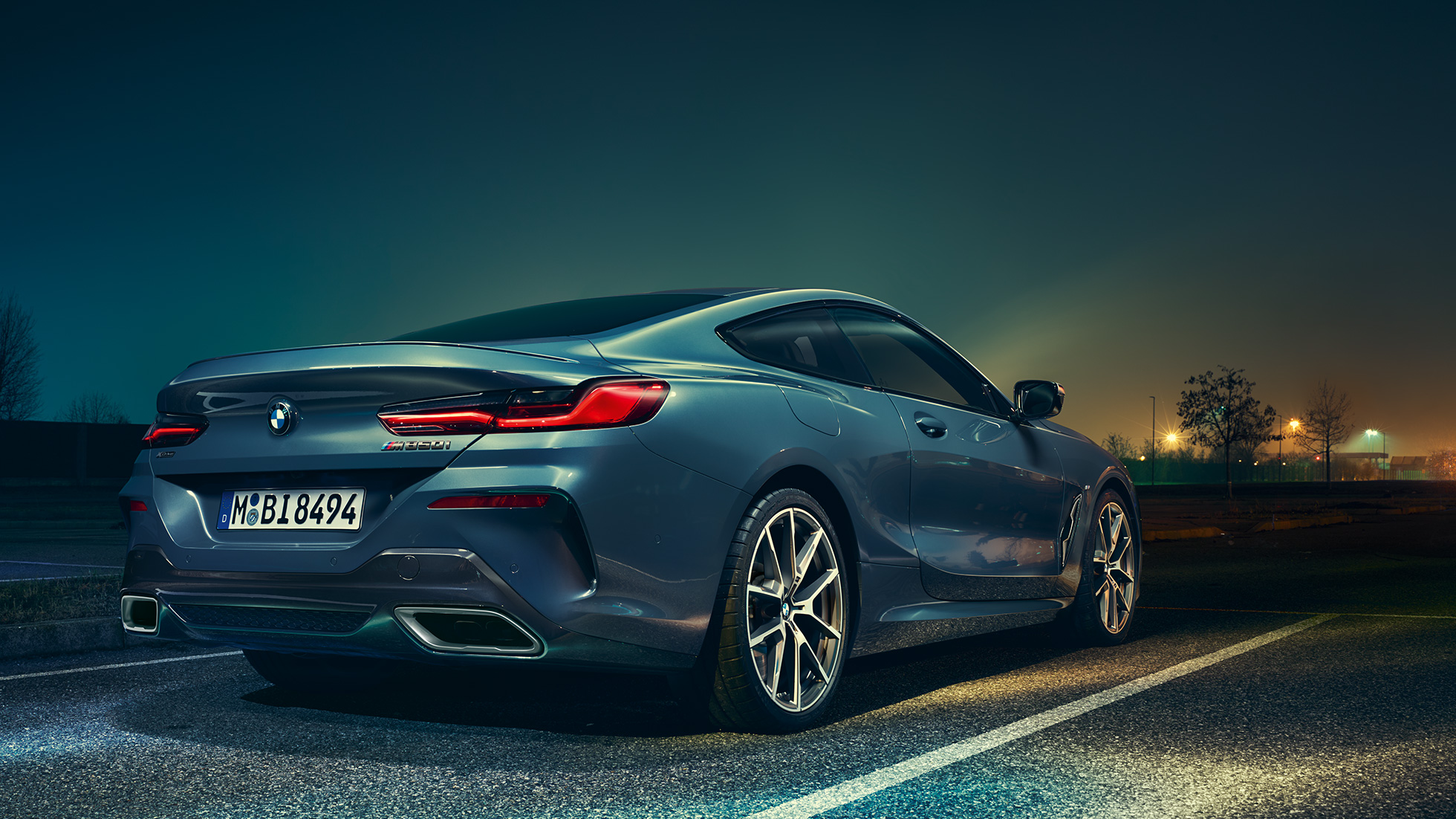 BMW 8 Series Coupé, three-quarter rear view. BMW 8 Series Coupé, three-quarter rear view, standing in front of night scenery.