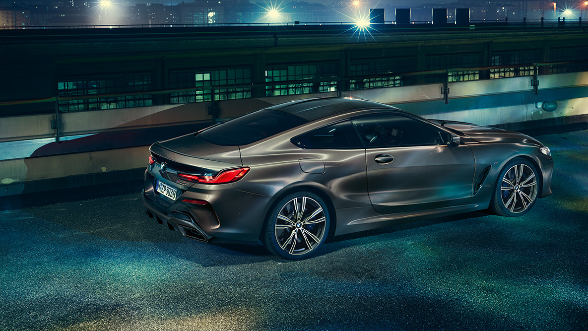 Still shot of the BMW 8 Series Coupé. Still shot of the BMW 8 Series Coupé with BMW Individual equipment from the side in an urban setting at night.