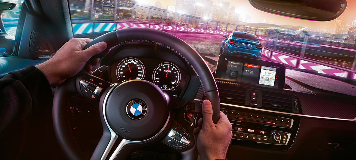 BMW M2 Competition cockpit Two BMW M2 Competition in racing situation at night, view from cockpit.