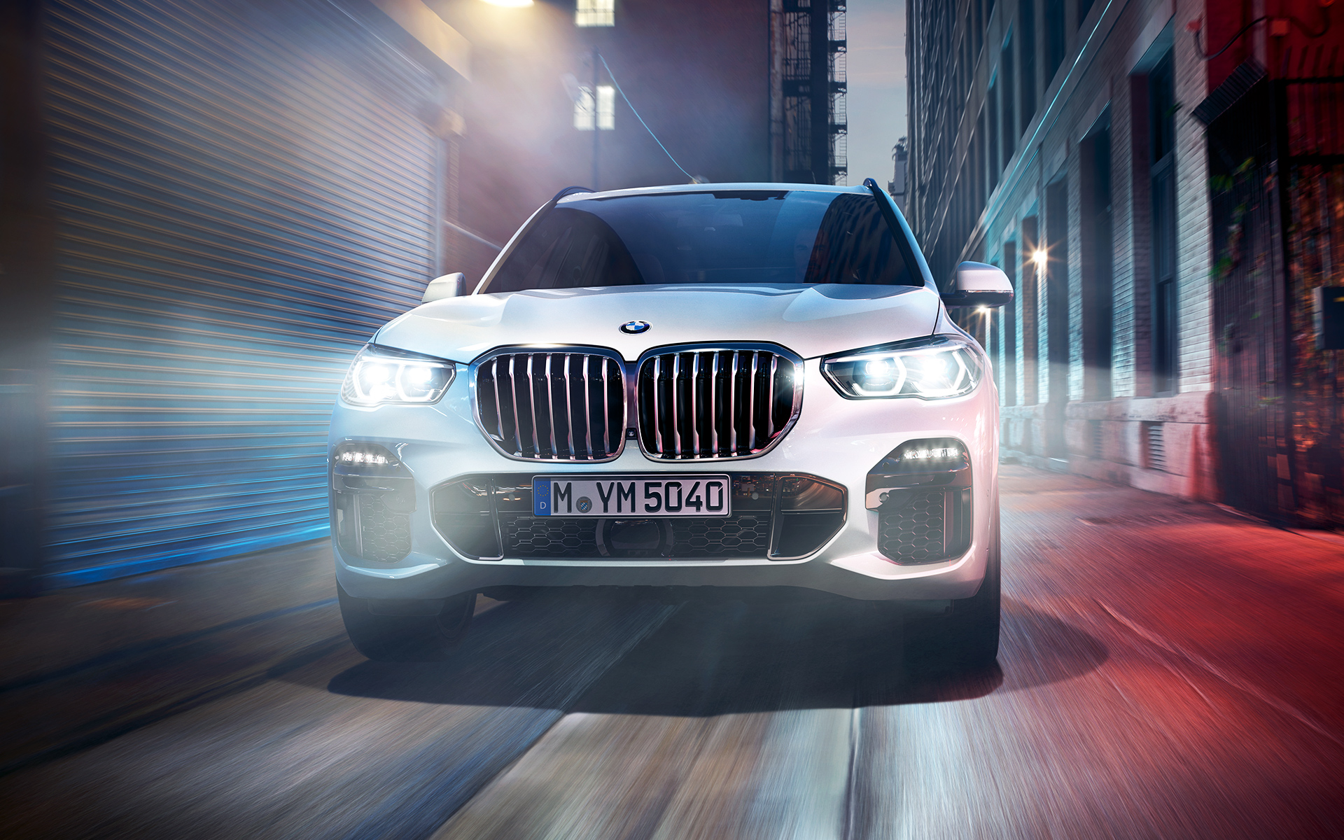 The BMW X5 on a street in the city at night