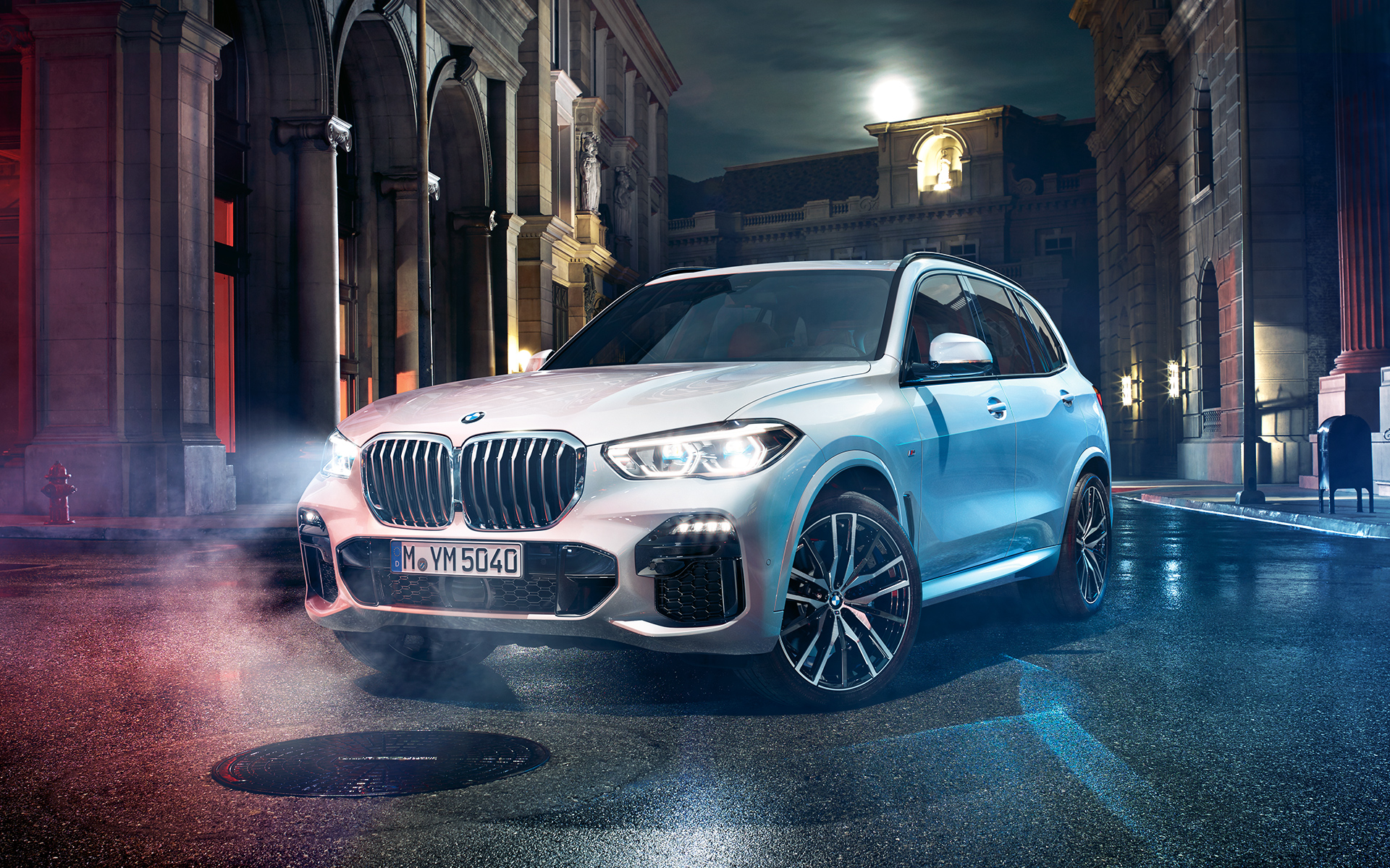 Front shot of the BMW X5 at night in an urban setting