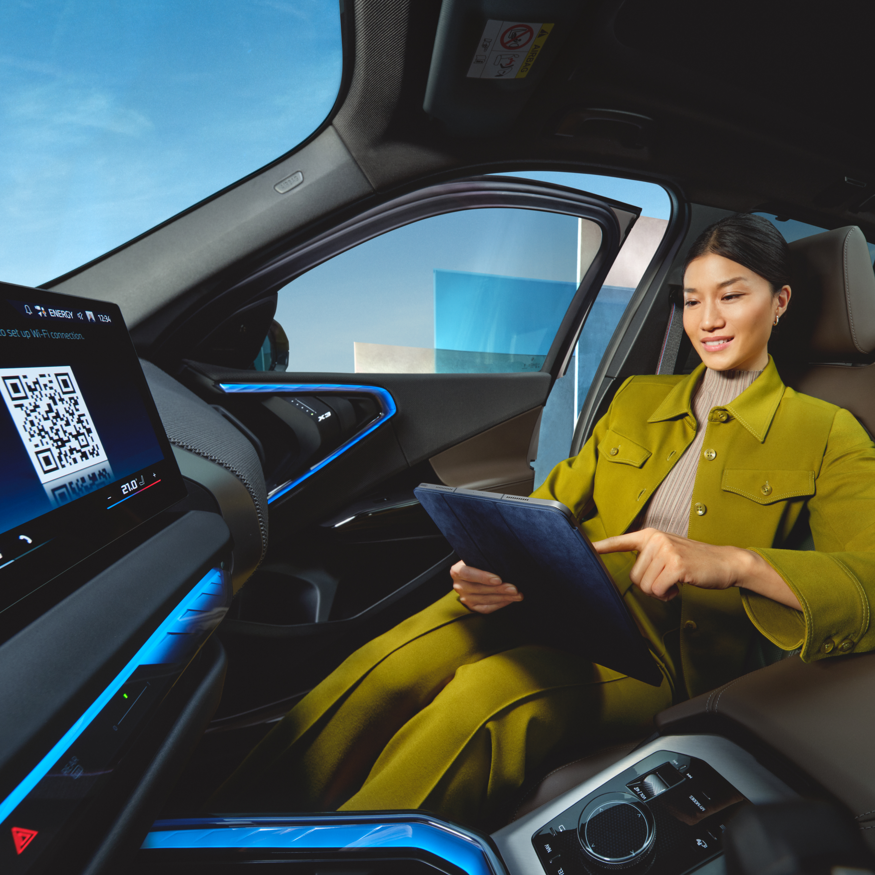 Person uses tablet in BMW